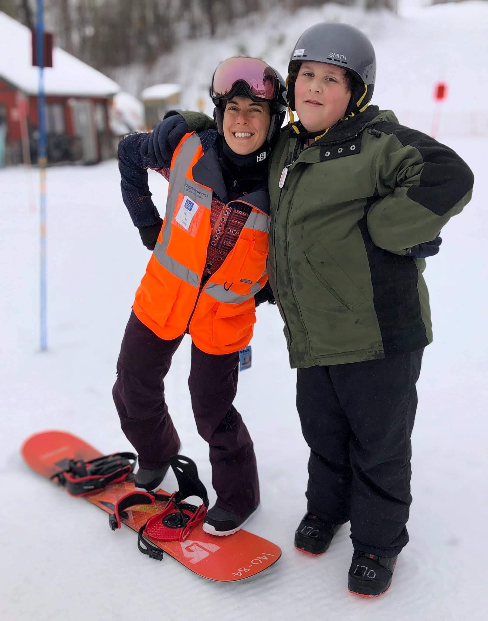 ASMS instructor and adaptive snowboarder posing together at Mount Snow