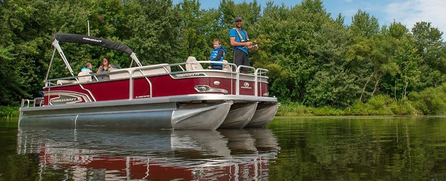 Photo of a Pontoon Boat with a person fishing off of it.